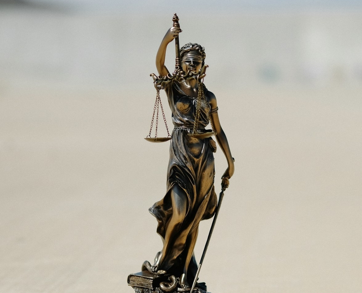 A statue of a lady justice holding a scale